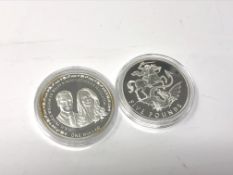 Two Elizabeth II silver proof coins comprising a 2020 £5 coin and a 2011 $1 coins commemorating the