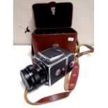 A vintage Kiev 80 camera with lens in a fitted leather case