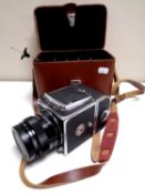 A vintage Kiev 80 camera with lens in a fitted leather case