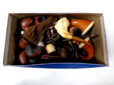 A box containing a collection of vintage pipes