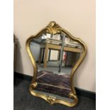 A gilt framed shaped mirror,