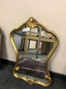 A gilt framed shaped mirror,