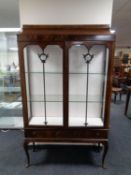 A late 19th century mahogany double door glazed display cabinet fitted two drawers beneath on