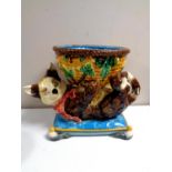 A Minton majolica jardiniere in the form of a cat playing with a wicker basket on cushion,