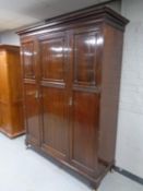 An Edwardian mahogany triple door wardrobe
