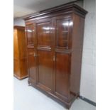 An Edwardian mahogany triple door wardrobe