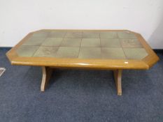 An octagonal tile topped refectory coffee table