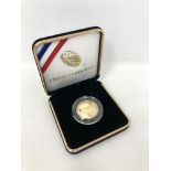 A US Mint 50th Anniversary Moon Landing gold coin in box. CONDITION REPORT: 8.