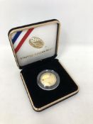 A US Mint 50th Anniversary Moon Landing gold coin in box. CONDITION REPORT: 8.