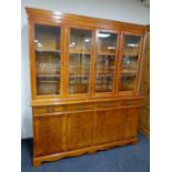 An inlaid yew wood four door bookcase
