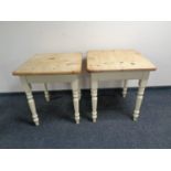 A pair of stripped pine square topped cafe tables on painted bases