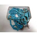 A box containing a quantity of turquoise fashion jewellery