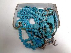 A box containing a quantity of turquoise fashion jewellery