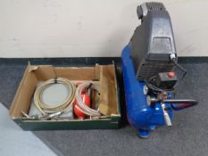 An Air com compressor together with a box containing compressor tools