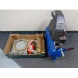 An Air com compressor together with a box containing compressor tools