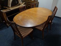 A 20th century oval teak G Plan extending dining table together with a set of five rail back chairs