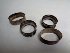 Two pairs of silver napkin rings