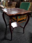 An Edwardian shaped two tier occasional table