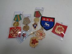 A box containing a quantity of Russian enamelled badges and medals