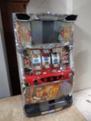 A Japanese table top electric fruit machine with key