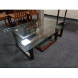 A contemporary glass topped coffee table