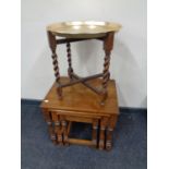 A brass topped table on folding barley twist stand together with a further nest of three tables