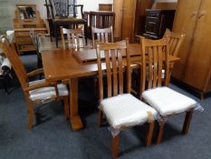 A contemporary oak refectory pull out dining table with leaf together with a set of six Arts &