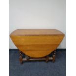 An Edwardian oak barley twist gate leg table