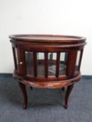 A reproduction oval drinks cabinet with lift off tray on raised legs