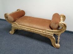 A contemporary scroll arm window seat with bolster cushions