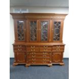 A reproduction Victorian style four door bookcase fitted secretaire cupboards and drawers beneath
