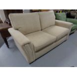 A Marks and Spencer settee upholstered in a beige fabric