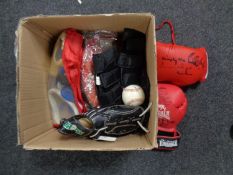 A box containing sporting equipment to include pair of signed boxing gloves,