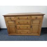 An Edwardian oak double door sideboard fitted six drawers