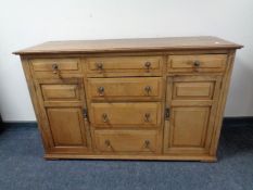 An Edwardian oak double door sideboard fitted six drawers