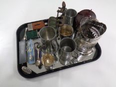 A tray containing cast iron pipe stand, a Bakelite tea caddy, assorted plates wares, hip flasks,