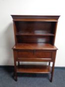 An Edwardian mahogany cabinet on raised legs fitted shelves above