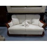 A Multi York two seater wood framed and bergere settee with scatter cushions
