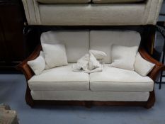 A Multi York two seater wood framed and bergere settee with scatter cushions