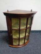 A mahogany glazed door hanging corner cupboard