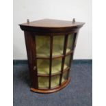 A mahogany glazed door hanging corner cupboard