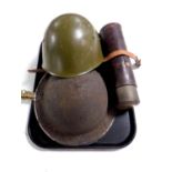 Two World War II tin helmets together with a vintage flask in leather sheath