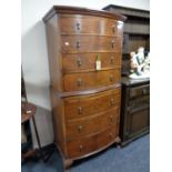 A late 19th century stained walnut seven drawer chest on chest with slide