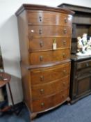 A late 19th century stained walnut seven drawer chest on chest with slide