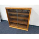 A walnut Art Deco bookcase with sliding glass doors