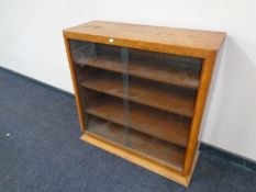 A walnut Art Deco bookcase with sliding glass doors