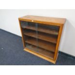 A walnut Art Deco bookcase with sliding glass doors