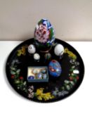 A circular papier mache tray together with eleven cloisonne eggs,