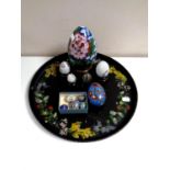 A circular papier mache tray together with eleven cloisonne eggs,