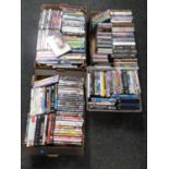 Four boxes containing a large quantity of DVDs and CDs,